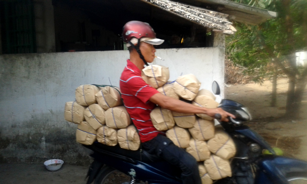 Scooter in Vietnam carrying loads of rice noodles