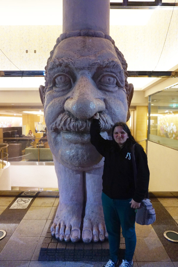 Face pillars outside the Dotonbori Hotel, Dotonbori, Osaka, Japan. I am sticking my hand up his nose.