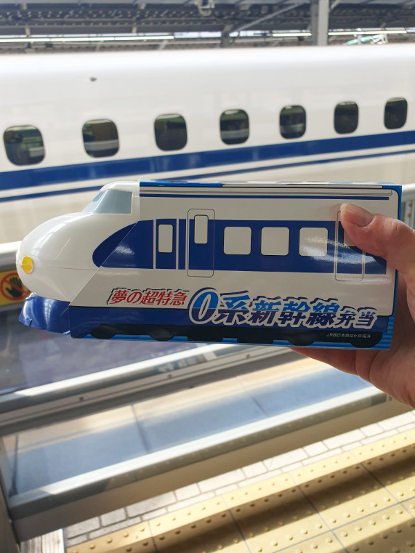 Train bento box with a bullet train in the background, Japan