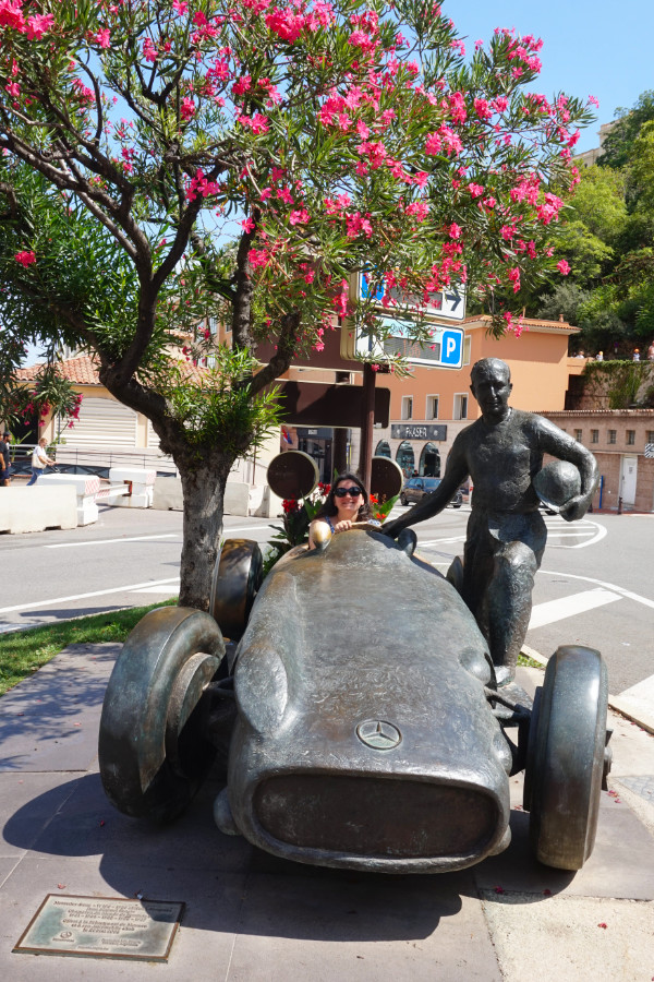 Me sitting in the car at the Juan Manuel Fangio Statue, Monaco