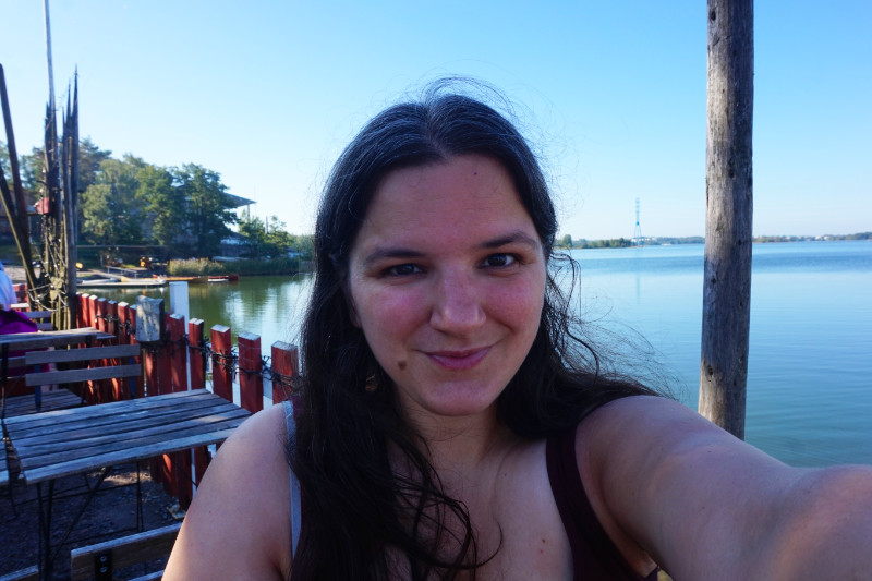 Me sitting at Regatta Cafe, Helsinki, Finland, next to the water.