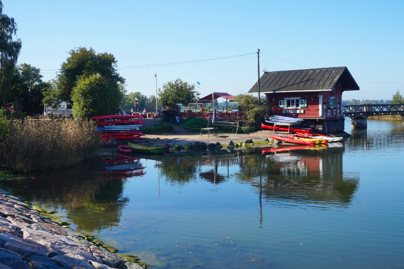 Sea next to Sibelius park, Helsinki, Finland. Regatta Cafe is beyond the water, with a row of kayaks in front of it.