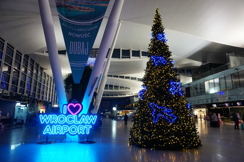 Christmas tree at Wroclaw Airport, Poland. The tree has blue lights on it shaped like aeroplanes.