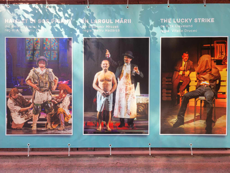 Theatre poster, Chisinau, Moldova. On the left is someone in an army costume, in the middle is a topless man in shorts having something poured over his head by a madman in an apron and bowler hat, and on the right is someone with a sack over his head tied to a chair. Totally normal.