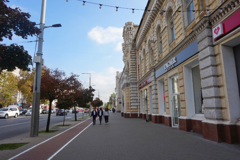 Stefan cel Mare, Chisinau, Moldova. Looking down the pavement of the boulevard with the Chiศinฤu Municipality Hall on the right hand side.