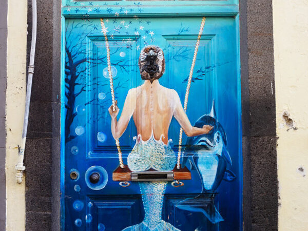 Painted door with a mermaid on a swing, Funchal, Madeira, Portugal