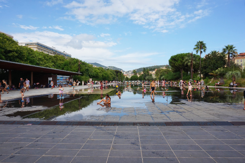 Place Massena, Nice, France. A lot of people enjoying the fountains in the park