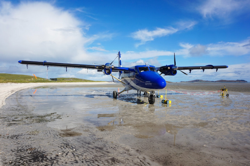 Twin Otter Loganair plane on the beach in Barra, Scotland