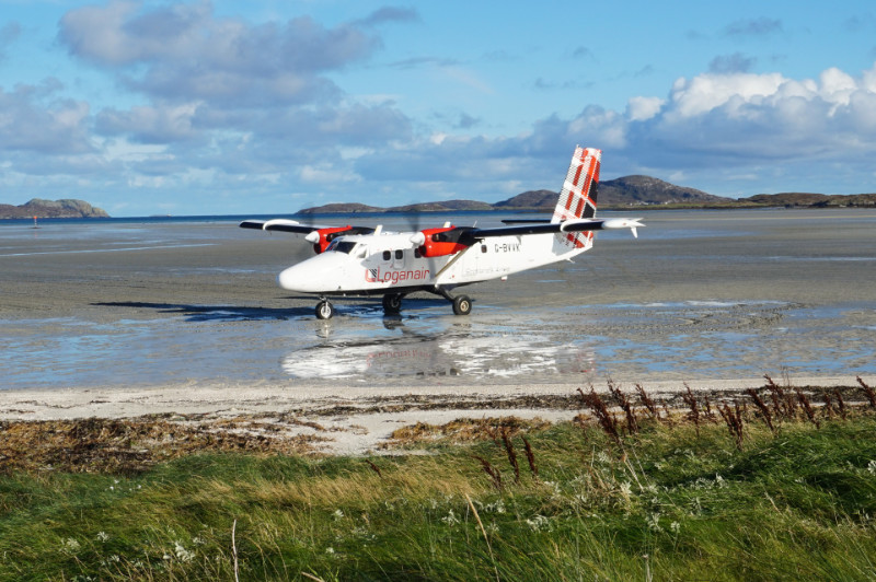 Twin Otter Loganair plane on the beach in Barra, Scotland