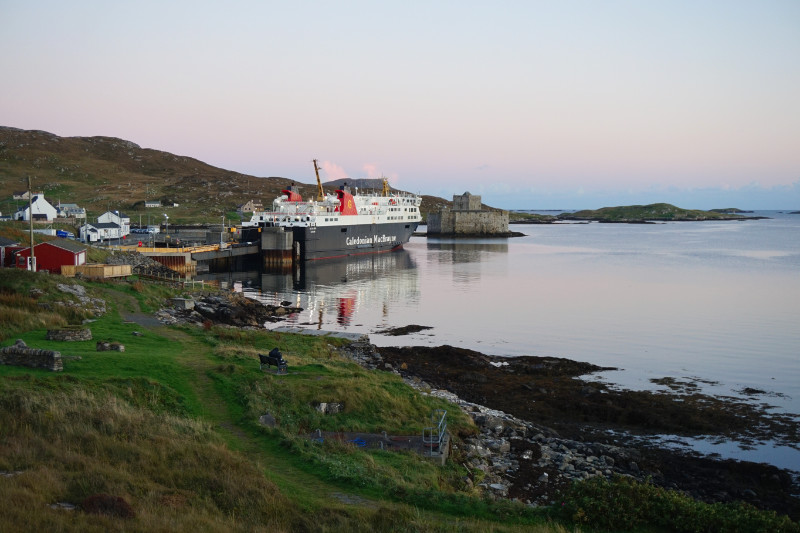 Castlebay, Barra at dusk. Overlooking Kisimul Bay with the ferry docked on the left, next to Kisimul Castle sitting in the water.