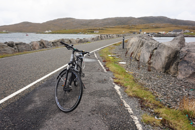 Causeway over from Barra to Vatersay, Scotland. My bike is barely standing in the wind.